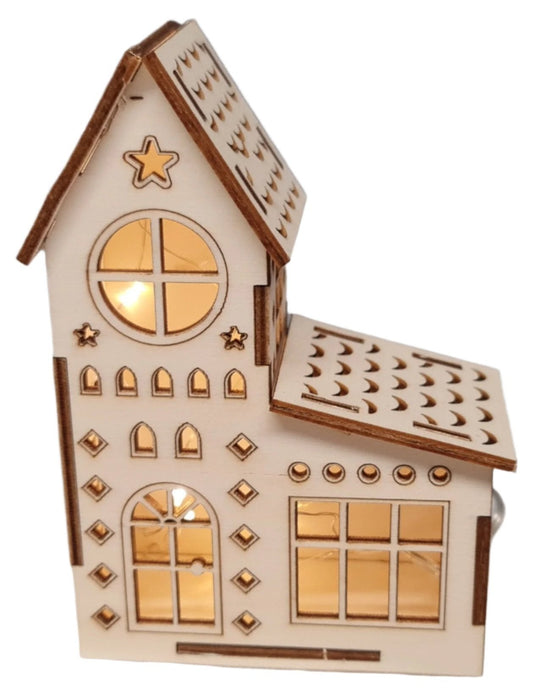 A charming small wooden Christmas house adorned with glowing lights, enhancing its appeal and warmth in the nighttime setting.